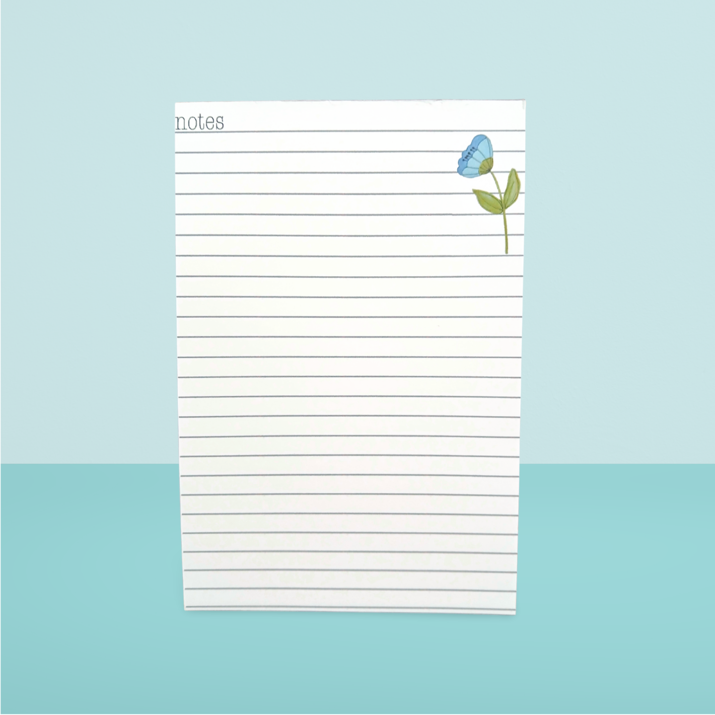 Notepad with a blue flower design on a light blue background