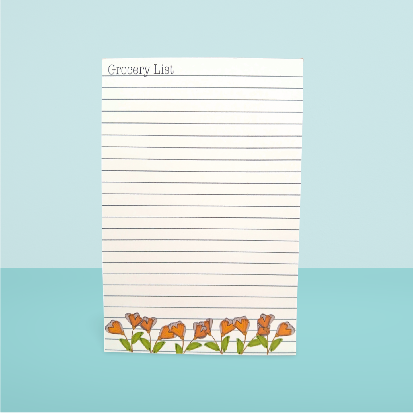 Grocery list notepad with orange flowers on a light blue background