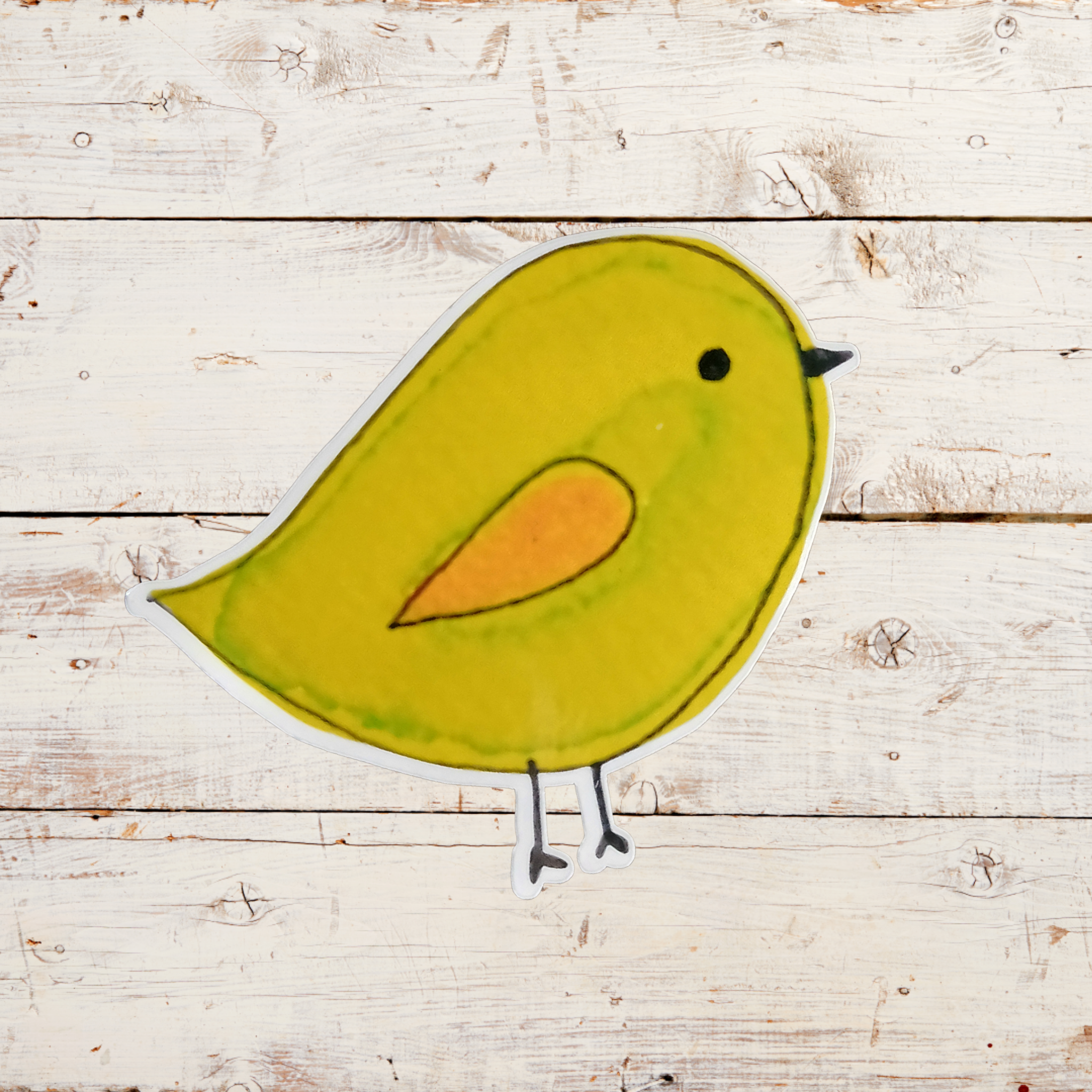 stickerof a green bird with  on a wooden surface