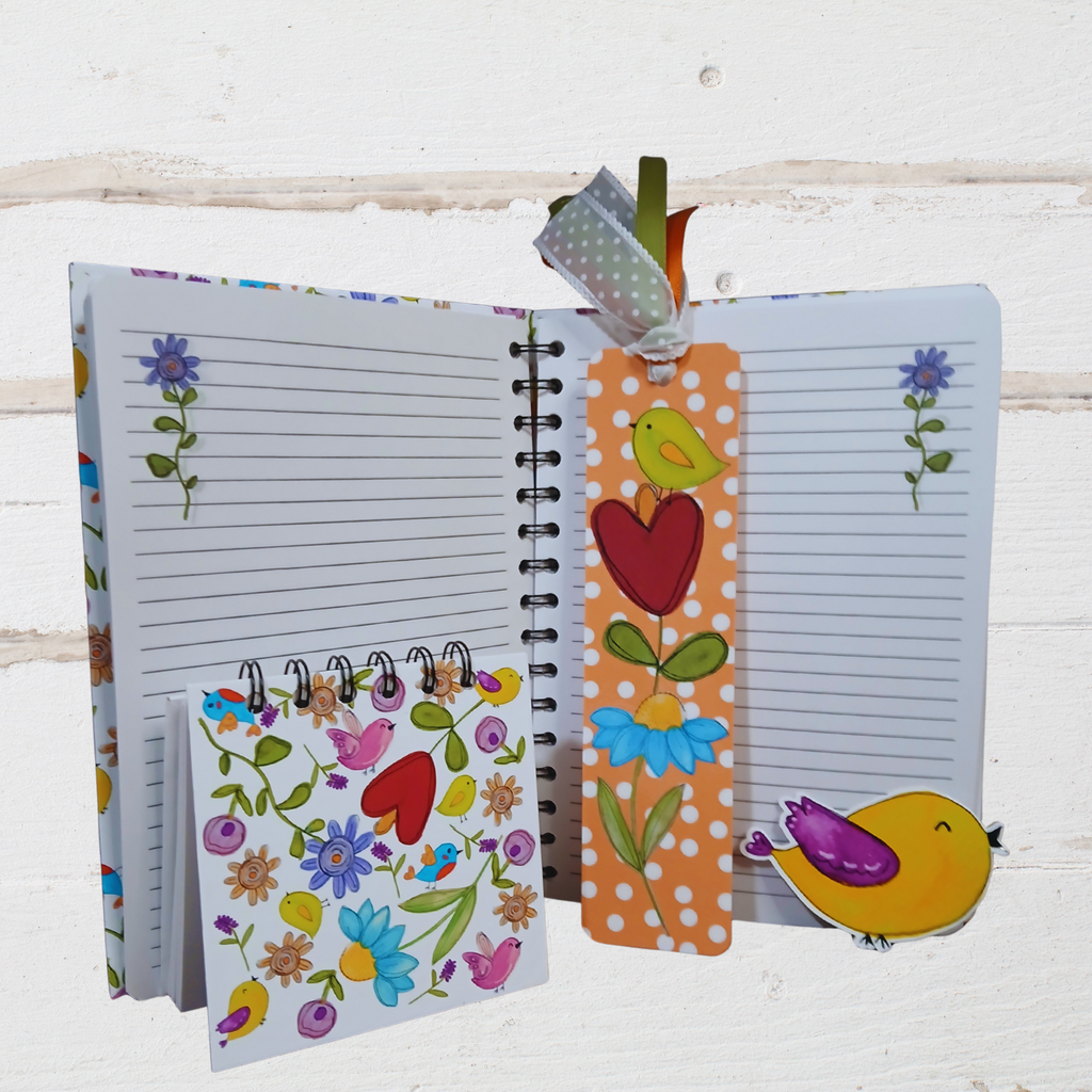 Open notebook with colorful bookmarks on a white wooden background