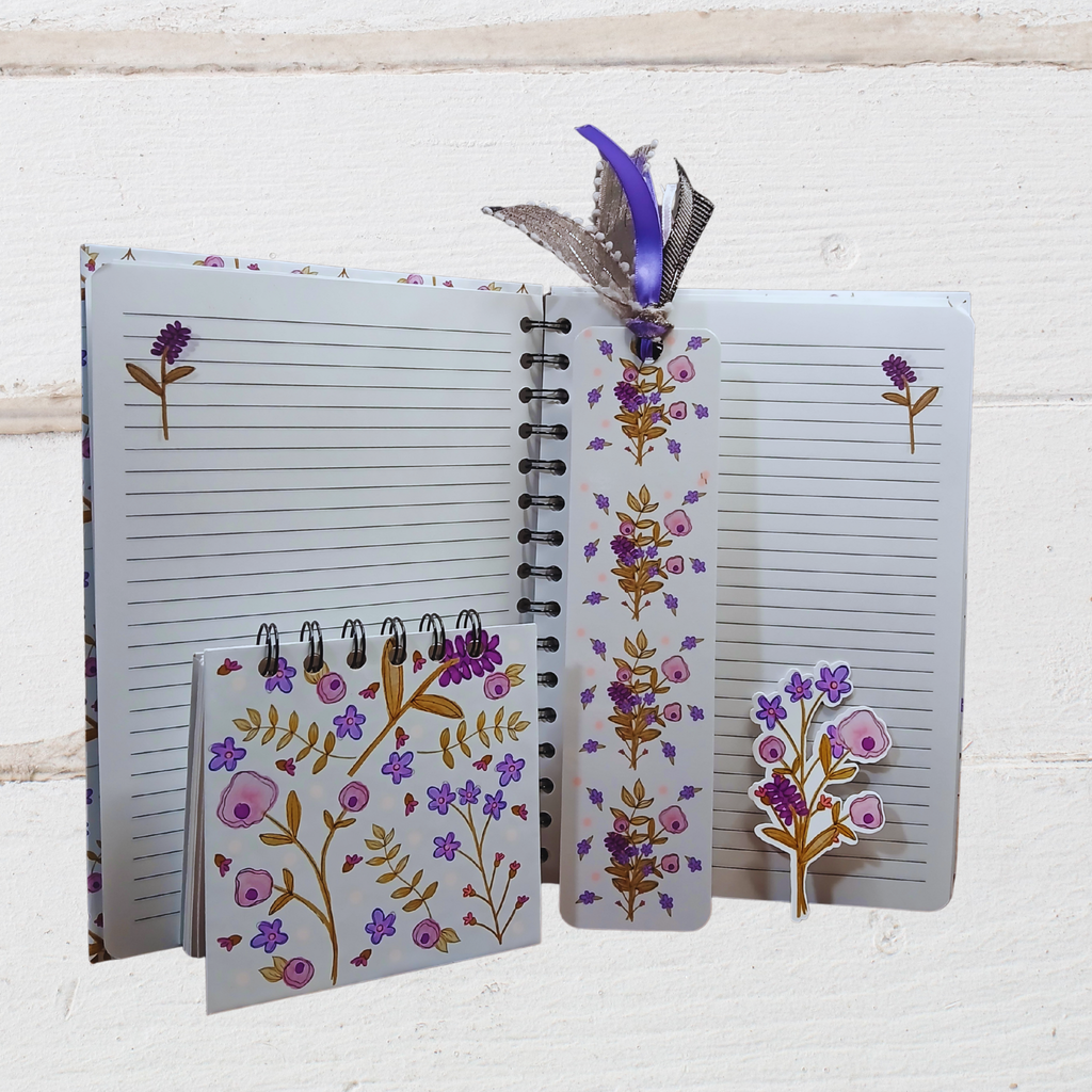 Open notebook with floral design on cover and pages, featuring a bookmark and pen holder.