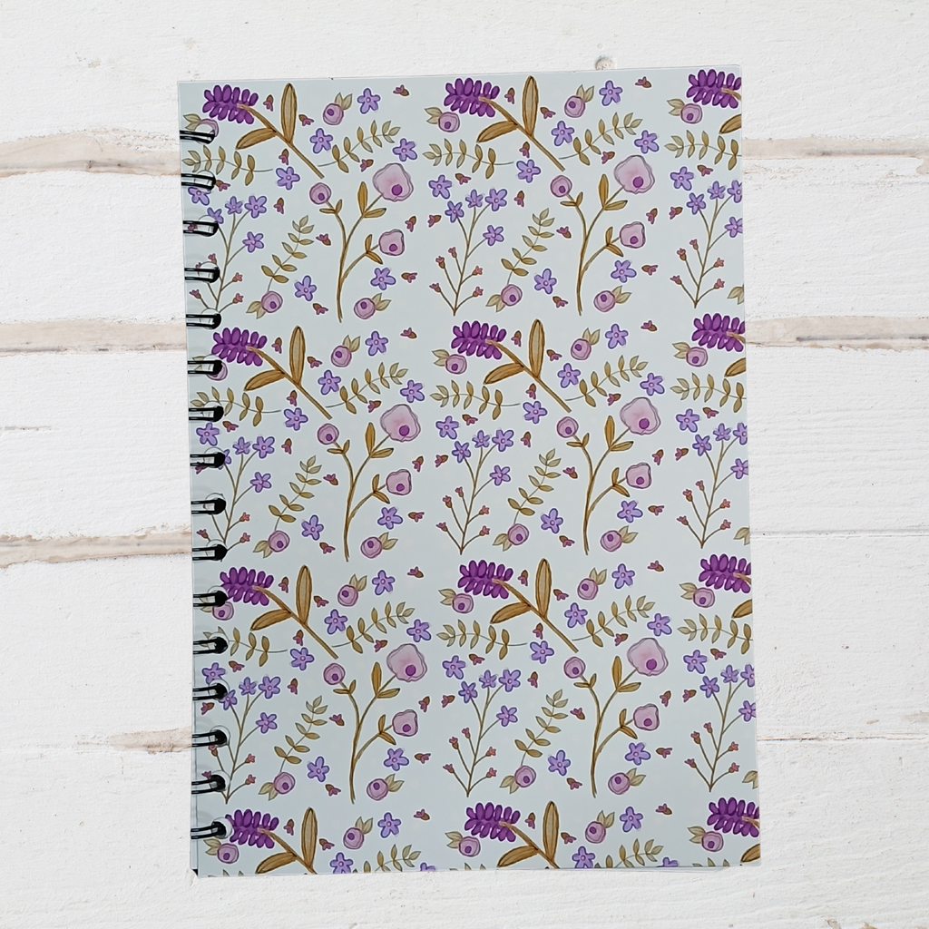 Notebook with floral pattern on a wooden surface
