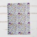 Notebook with floral pattern on a wooden surface
