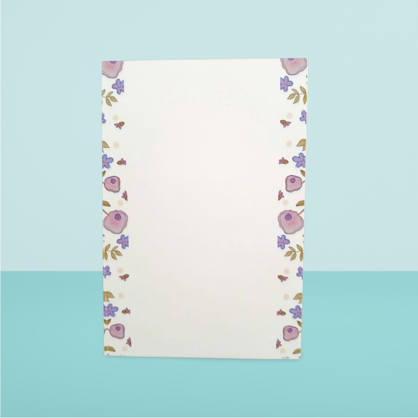 Floral patterned paper on a light blue background
