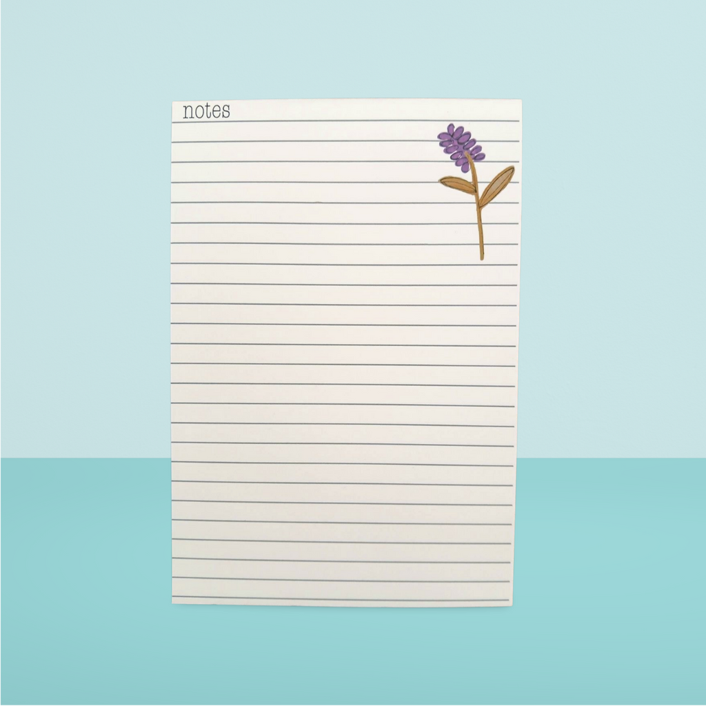 Notepad with a flower design on a light blue background