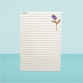 Notepad with a flower design on a light blue background