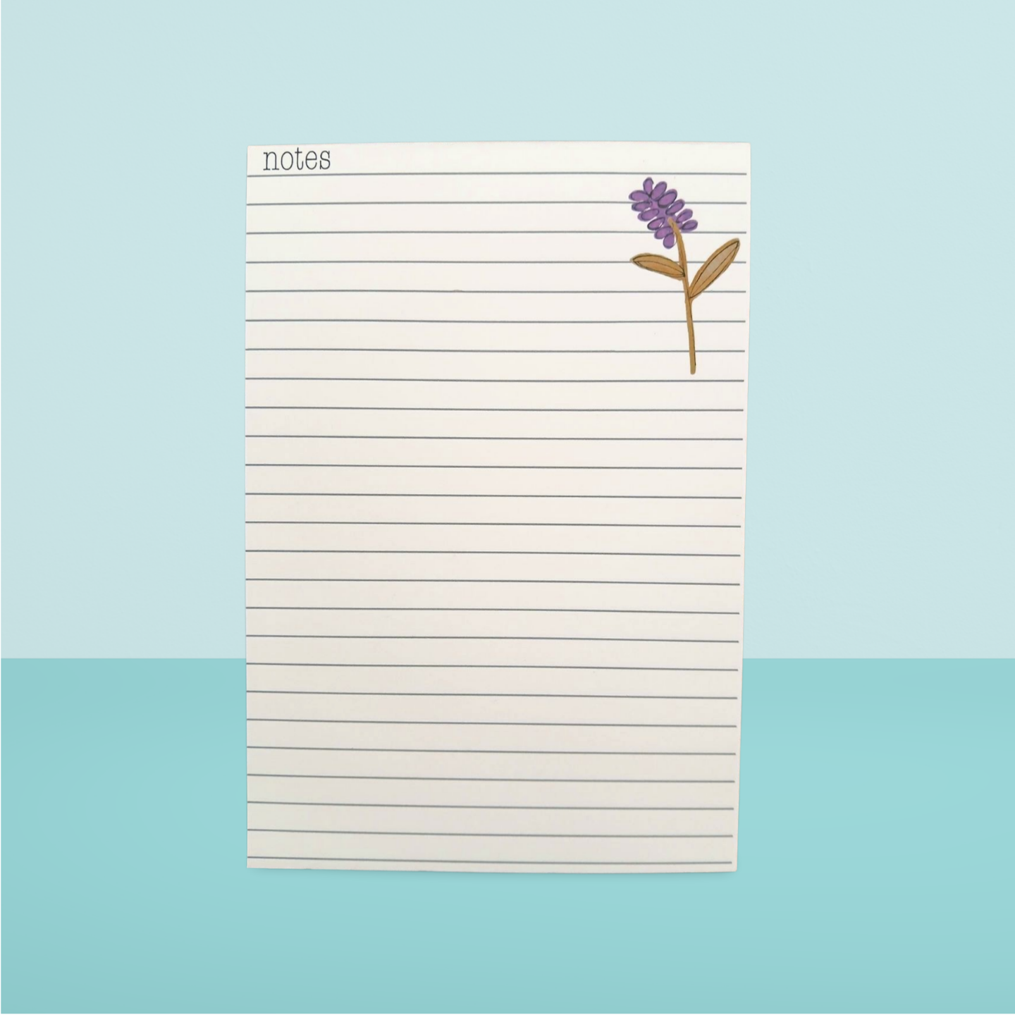 Notepad with a flower design on a light blue background