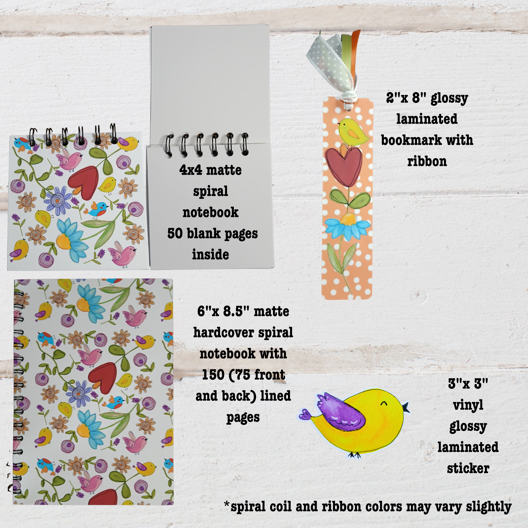Set of stationery items including  4"x 4" and  6"x 8.5" notebooks, 2"x 8" bookmark, and stickers on a wooden surface.