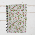 Notebook with floral pattern on a wooden surface