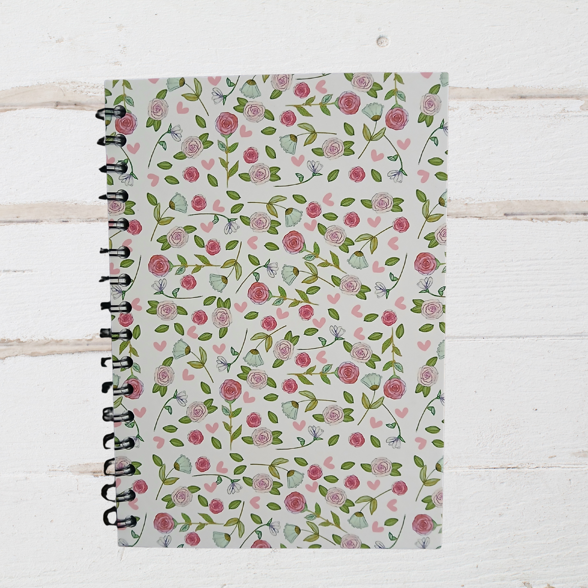 Notebook with floral pattern on a wooden surface
