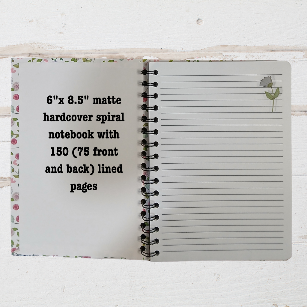 Open notebook showing inside pages with text 6"x 8.5" notebook. on a white background