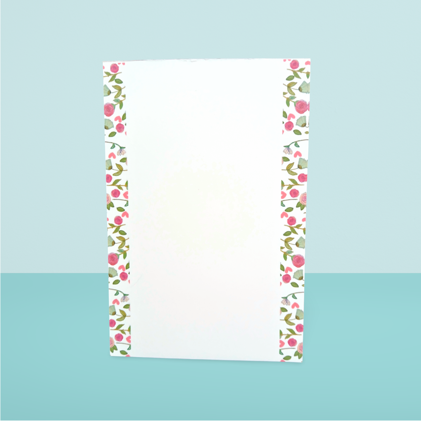 Floral border notepad on a light blue background
