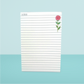 Notepad with a rose design on a light blue background