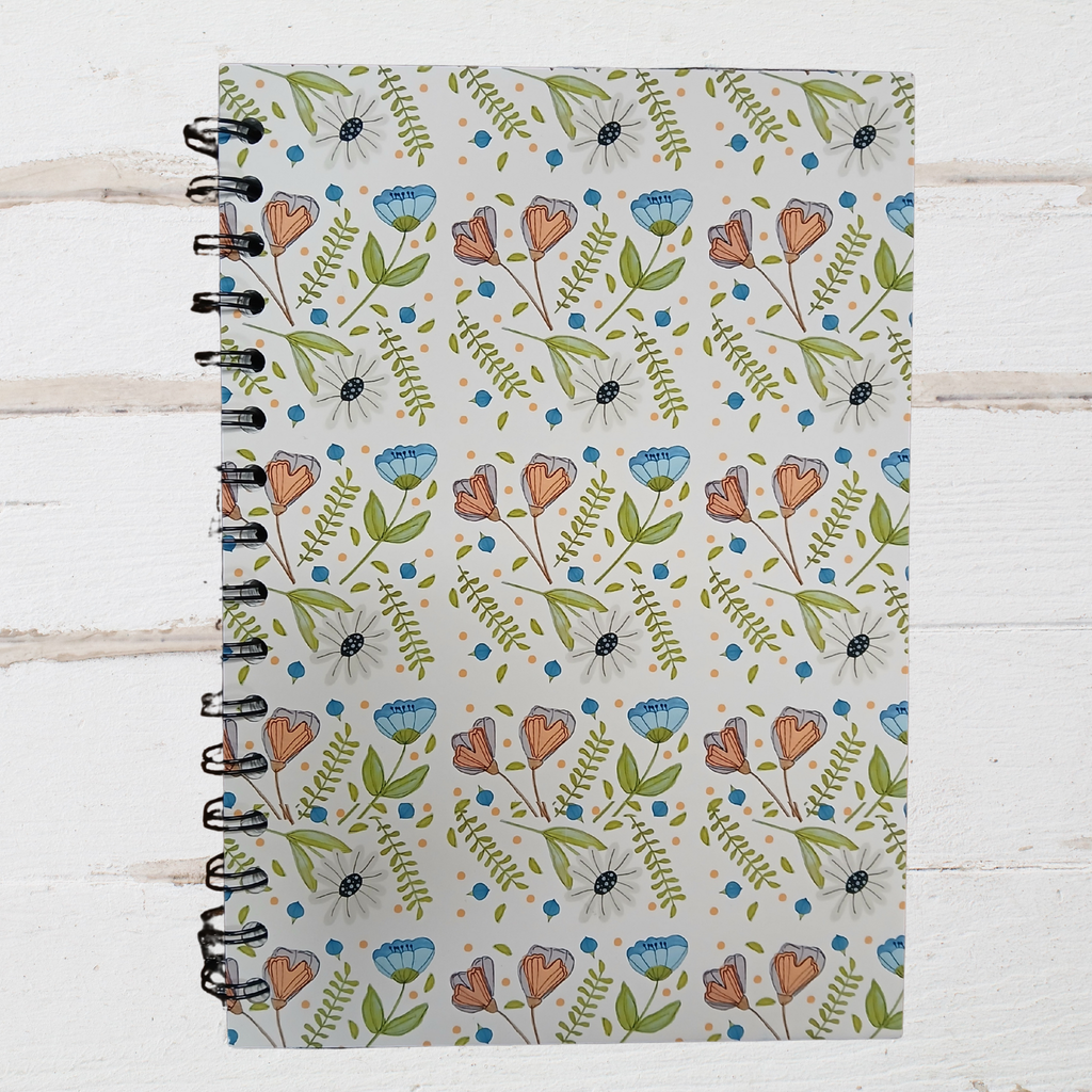 Notebook with floral pattern on a wooden surface