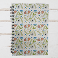 Notebook with floral pattern on a wooden surface