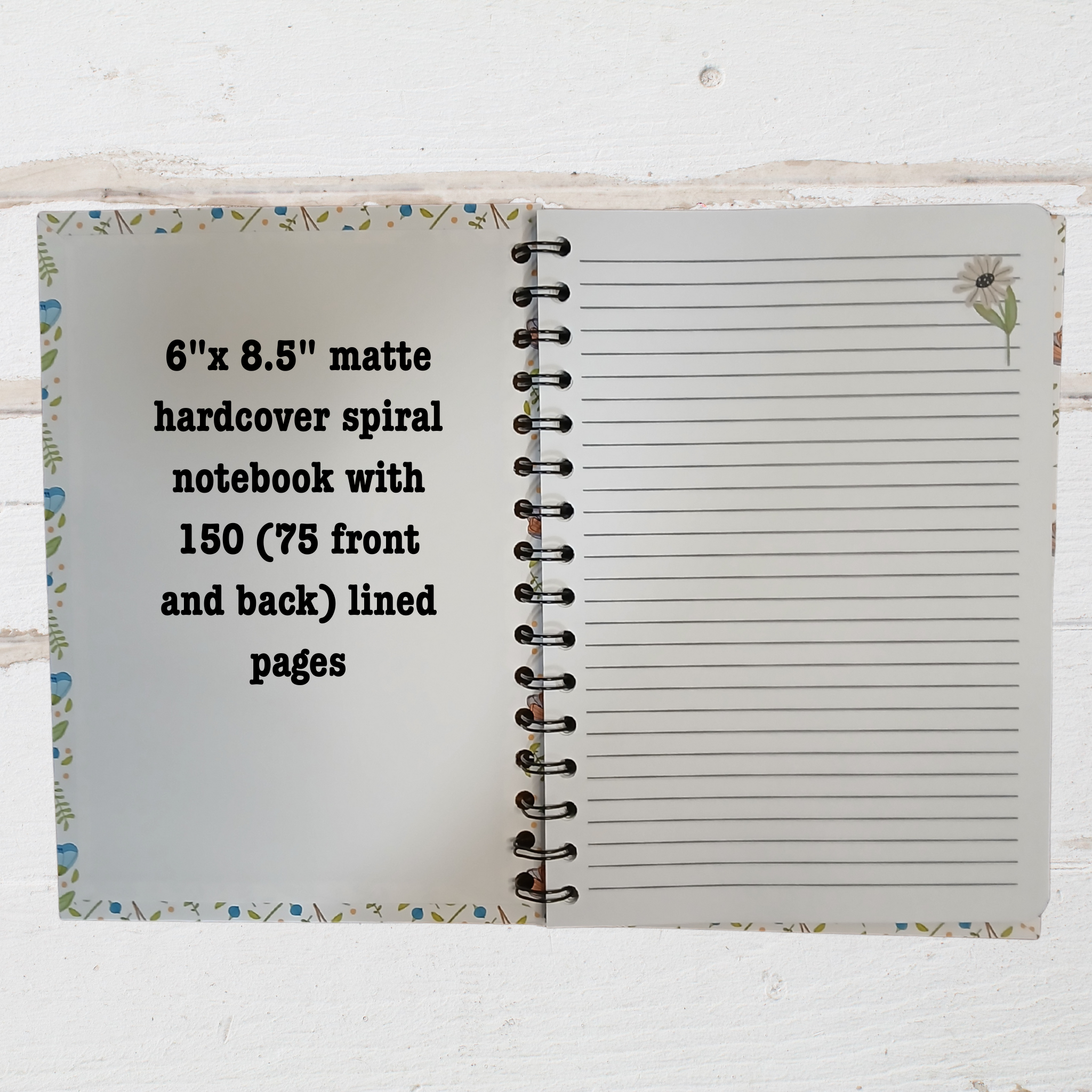 Open notebook showing lined pages with text  6"x 8.5" notebook.