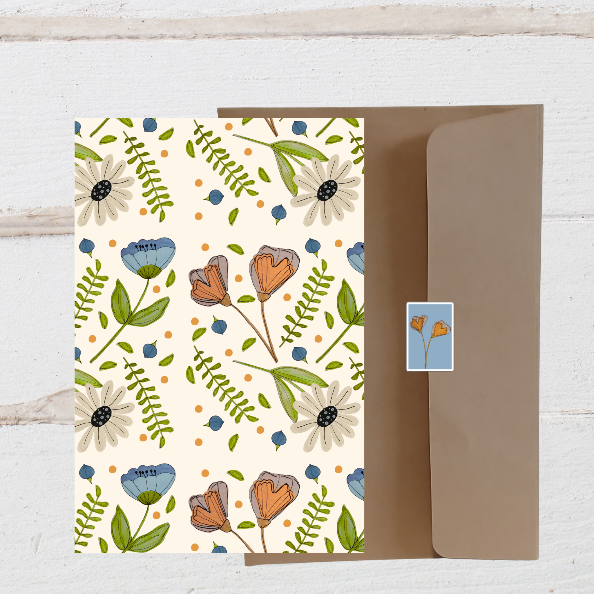 Floral patterned card with a matching envelope on a light wooden surface