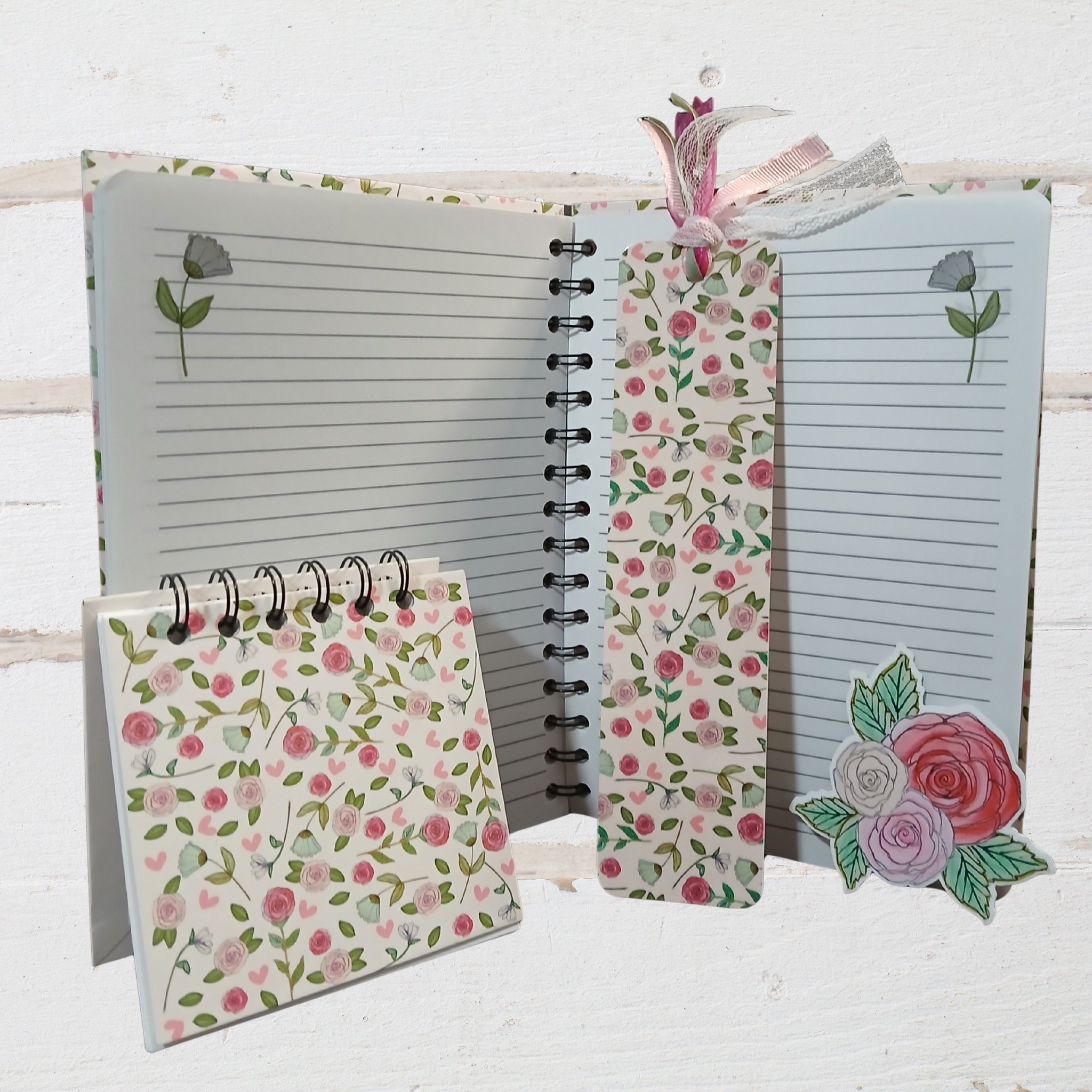 Notebook with floral design on a white wooden surface